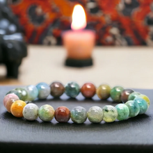 Load image into Gallery viewer, Lifestyle shot of a Indian Agate bracelet on a person's wrist, emphasizing comfort and beauty.