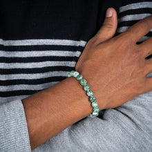Load image into Gallery viewer, Lifestyle shot of a Tree Agate bracelet on a person's wrist, emphasizing comfort and beauty.