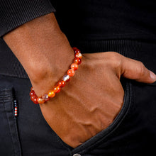 Load image into Gallery viewer, Lifestyle shot of a Red Sulemani Hakik bracelet on a person's wrist, emphasizing comfort and beauty.