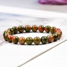 Load image into Gallery viewer, Model wearing a stylish Unakite bracelet to highlight its elegance and aesthetic appeal. Get to know more about the Unakite benefits