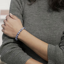 Load image into Gallery viewer, Lifestyle shot of a Sodalite bracelet on a person's wrist, emphasizing comfort and beauty.