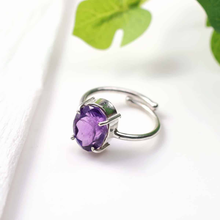 Load image into Gallery viewer, Amethyst diamond cut oval ring placed on a white table, promoting spiritual awareness, intuition and inner peace.