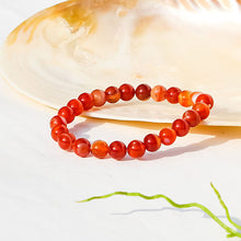 Load image into Gallery viewer, The Red Sulemani Hakik bracelet with a focus on its vibrant color and unique texture.