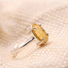 Load image into Gallery viewer, Close-up of Citrine diamond cut oval ring on a textured fabric surface, symbolizing success, prosperity and positive energy.