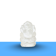 Load image into Gallery viewer, Clear quartz Ganesh figurine on a minimalist white and blue background, showing polished details and elegant design