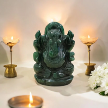 Load image into Gallery viewer, Dark green Ganesh stone figurine, front view with diya and white flowers, polished carved details