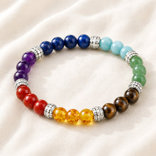Load image into Gallery viewer, 7 Chakra Bracelet displayed fully on white silk cloth to show its natural colour, shape and finish