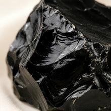 Load image into Gallery viewer, Close-up of authentic natural Black Obsidian showing crystal texture, colour and craftsmanship – black obsidian raw stone symbol of protection grounding and