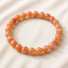 Load image into Gallery viewer, Carnelian Bracelet displayed fully on white silk cloth to show its natural colour, shape and finish