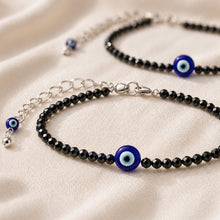 Load image into Gallery viewer, Evil Eye with Black Tourmaline Anklet with Free Selenite Charging Plate displayed fully on white silk cloth to show its natural colour, shape and finish