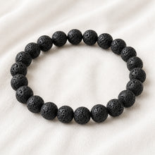 Load image into Gallery viewer, Lava Extract Bracelet displayed fully on white silk cloth to show its natural colour, shape and finish