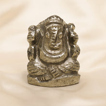 Load image into Gallery viewer, Pyrite Ganesh Idol displayed fully on white silk cloth to show its natural colour, shape and finish