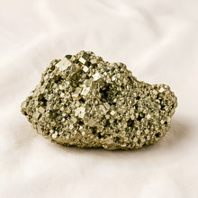 Load image into Gallery viewer, Raw Pyrite Raw Stone displayed fully on white silk cloth to show its natural colour, shape and finish