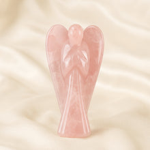 Load image into Gallery viewer, Rose Quartz Angel Figurine displayed fully on white silk cloth to show its natural colour, shape and finish