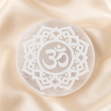 Load image into Gallery viewer, Selenite OM Charging Plate displayed fully on white silk cloth to show its natural colour, shape and finish