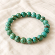 Load image into Gallery viewer, Turquoise Green Bracelet displayed fully on white silk cloth to show its natural colour, shape and finish
