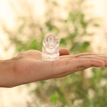 Load image into Gallery viewer, Hand-held clear quartz Ganesh figurine, highlighting detailed craftsmanship and serene appearance with soft natural light