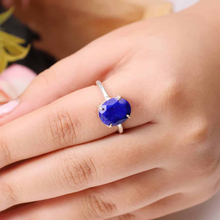 Load image into Gallery viewer, Diamond-cut Lapis Lazuli gemstone ring showcased on a finger, highlighting its faceted finish and elegant band.