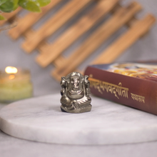 Load image into Gallery viewer, Pyrite Ganesh figurine with Geeta beside it, symbolizing abundance, prosperity and protection.