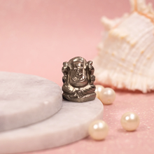 Load image into Gallery viewer, Pyrite Stone Ganesh figurine placed on a smooth soft pink backdrop