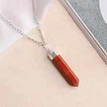 Load image into Gallery viewer, Red Jasper pencil pendant with a silver chain placed on a soft beige and white background