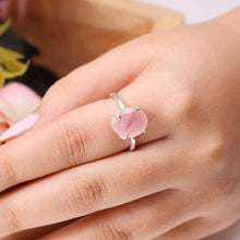 Load image into Gallery viewer, Rose Quartz oval diamond cut ring on a clean white background with blue accents, enhancing love, harmony and self-love.