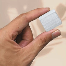 Load image into Gallery viewer, Selenite raw crystal cluster held in hand against a soft pink background for cleansing and clarity.