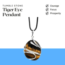Load image into Gallery viewer, Tiger Eye tumble pendant photographed outdoors with greenery and soft natural light in the background