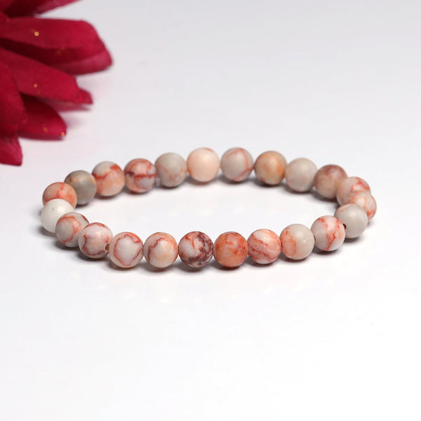 The Red Picasso Jasper bracelet with a focus on its vibrant color and unique texture.