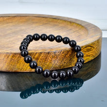 Load image into Gallery viewer, A collection of Black Obsidian bracelet showcasing different styles and sizes along with their Black Obsidian bracelet benefits.
