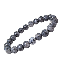 Load image into Gallery viewer, Model wearing a stylish Larvikite bracelet to highlight its elegance and aesthetic appeal. Get to know more about the Larvikite benefits
