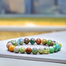 Load image into Gallery viewer, The Indian Agate bracelet with a focus on its vibrant color and unique texture.
