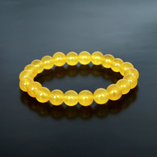 Load image into Gallery viewer, Model wearing a stylish Yellow Jade bracelet to highlight its elegance and aesthetic appeal. Get to know more about the Yellow Jade benefits
