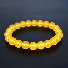 Load image into Gallery viewer, The Yellow Jade bracelet with a focus on its vibrant color and unique texture.
