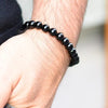 Lifestyle shot of a Black Onyx bracelet on a person's wrist, emphasizing comfort and beauty.