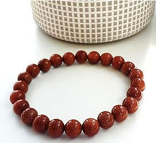 Load image into Gallery viewer, The Red Sunstone bracelet with a focus on its vibrant color and unique texture.
