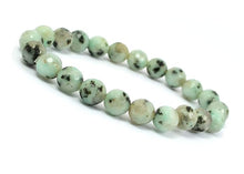 Load image into Gallery viewer, Model wearing a stylish Kiwi Jasper bracelet to highlight its elegance and aesthetic appeal. Get to know more about the Kiwi Jasper benefits
