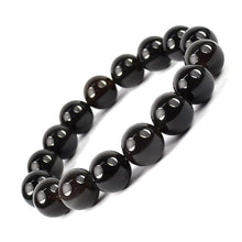 Load image into Gallery viewer, Model wearing a stylish Black Obsidian bracelet to highlight its elegance and aesthetic appeal. Get to know more about the Black Obsidian benefits

