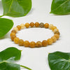The Yellow Aventurine bracelet with a focus on its vibrant color and unique texture.