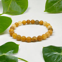 Load image into Gallery viewer, The Yellow Aventurine bracelet with a focus on its vibrant color and unique texture.
