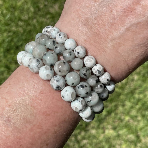 Lifestyle shot of a Kiwi Jasper bracelet on a person's wrist, emphasizing comfort and beauty.