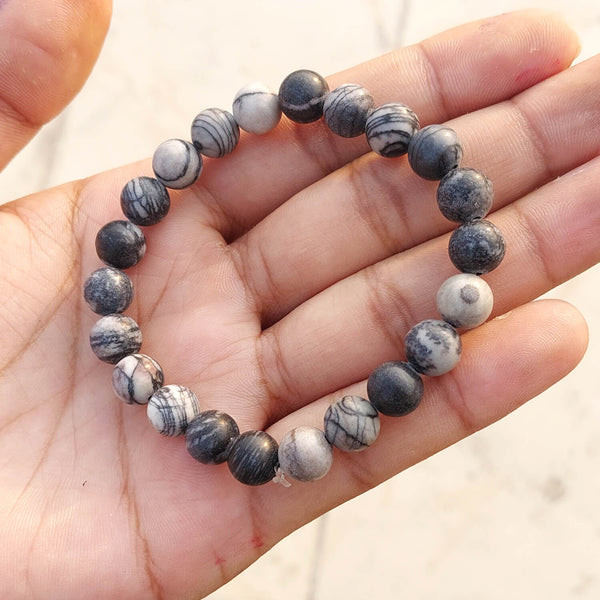 A collection of Black Picasso Jasper bracelet showcasing different styles and sizes along with their Black Picasso Jasper bracelet benefits.