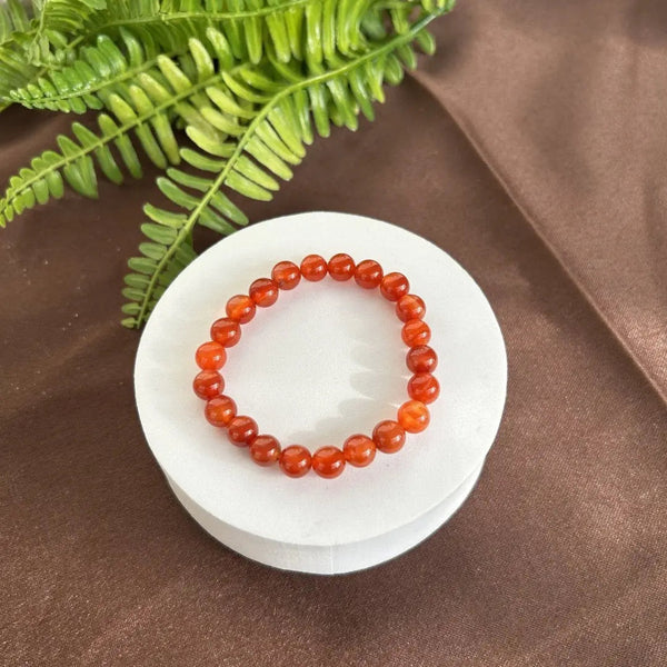 The Carnelian bracelet with a focus on its vibrant color and unique texture.