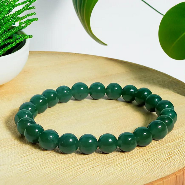 The Green Jade bracelet with a focus on its vibrant color and unique texture.