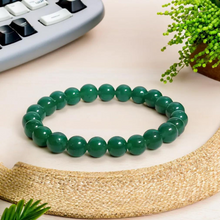 Load image into Gallery viewer, Model wearing a stylish Green Jade bracelet to highlight its elegance and aesthetic appeal. Get to know more about the Green Jade benefits
