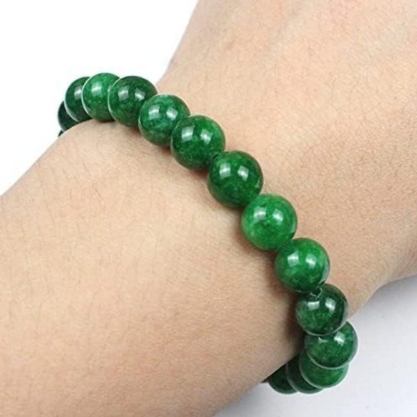 Lifestyle shot of a Green Jade bracelet on a person's wrist, emphasizing comfort and beauty.