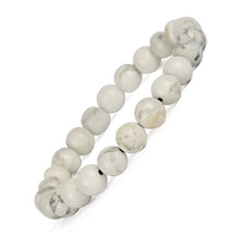 Load image into Gallery viewer, Model wearing a stylish Howlite bracelet to highlight its elegance and aesthetic appeal. Get to know more about the Howlite benefits
