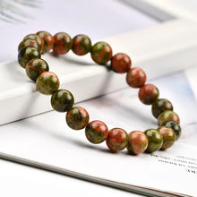 Load image into Gallery viewer, A collection of Unakite bracelet showcasing different styles and sizes along with their Unakite bracelet benefits.
