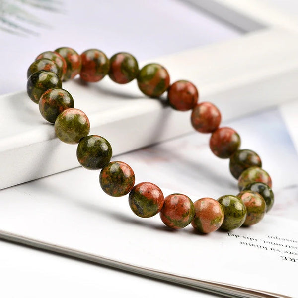 A collection of Unakite bracelet showcasing different styles and sizes along with their Unakite bracelet benefits.