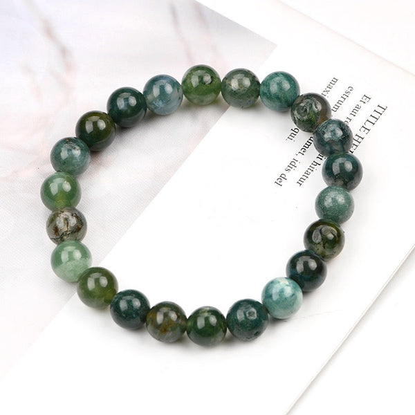 A collection of Moss Agate bracelet showcasing different styles and sizes along with their Moss Agate bracelet benefits.